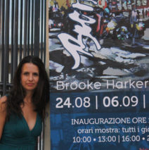 artist Brooke Harker with Italian banner