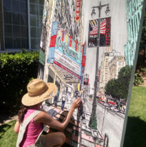 artist painting Broadway in downtown LA by the Orpheum Theatre