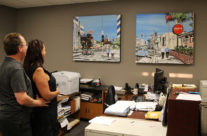 art collectors with paintings in their office by Brooke Harker