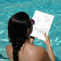 artist Brooke Harker sketching in a pool in Palm Springs