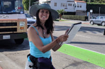 artist Brooke Harker with a belt of rainbow pencils